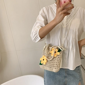 Handmade crochet knit bucket bag with yellow floral details and pearl bead strap