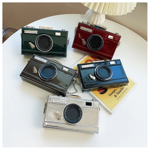 Detail shot of vintage camera bags in five colors with metallic chain and glossy finish