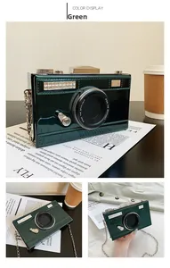Detail of green camera-shaped crossbody bag with glossy patent leather and gold chain