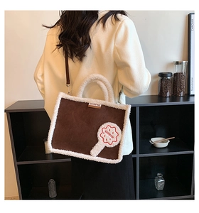 Detailed back view of a plush tote bag featuring brown faux suede and white faux fur trim