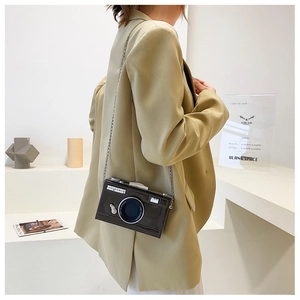Detailed close-up of a vintage camera-shaped crossbody bag with a shiny metal chain strap