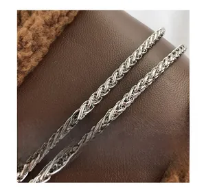 Detail of elegant silver wheat chain strap on a brown plush and leather handbag