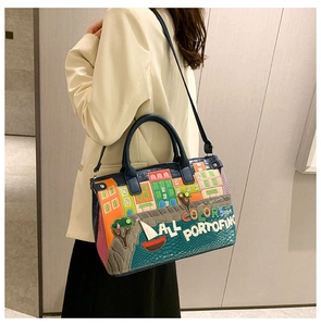 Detailed embroidery of Portofino scenery on large blue leather tote bag with shoulder strap