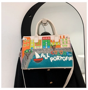 Detail of Portofino embroidery on a textured cream handbag with Mediterranean motifs