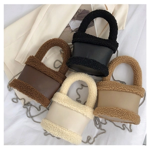 Flat lay of plush bucket bags in black, brown, white and khaki with chain straps