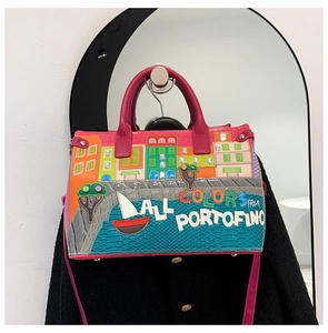 Detailed embroidery of Portofino harbor with colorful houses on a pink handbag