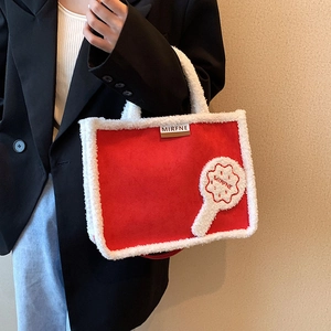 Large red plush tote bag with white fleece trim and designer logo for autumn winter style
