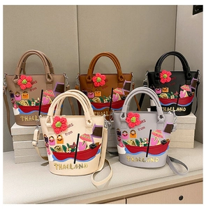 Detail of five assorted leather bucket bags featuring exotic embroidery and floral charms