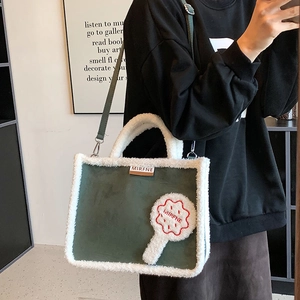 Furry large capacity tote bag in dark green suede with white plush trim and shoulder strap