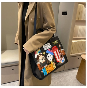 Detail of colorful pop-art patches and embroidery on black leather tote bag
