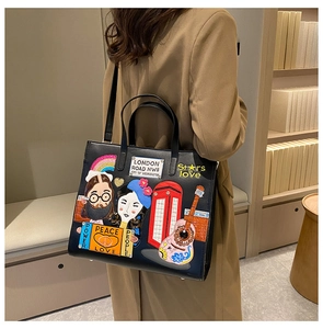 Detail of embroidered patch tote bag with London motifs worn by model in a library