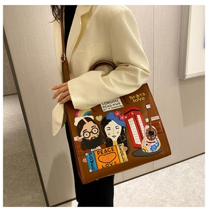 Detail of a brown leather tote with colorful pop art embroidery and London themes