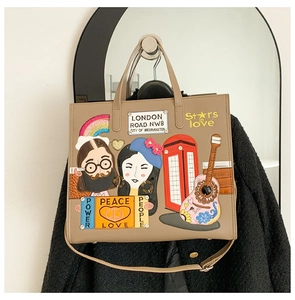 Detail of khaki tote bag with John Lennon and Yoko Ono embroidery and British motifs