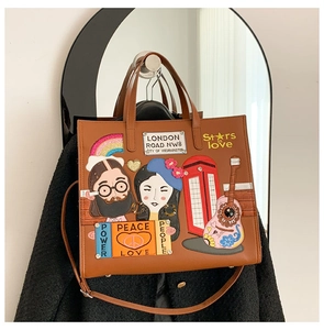 Detail of vintage brown tote with British-themed embroidery and London road patch