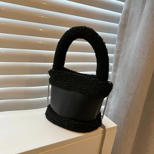 Chic black plush bucket bag with leather accents and silver chain strap for women