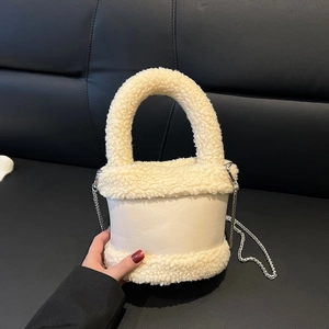 Plush cream white bucket bag with faux fur trim and silver chain strap for winter fashion
