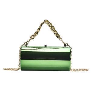 Sac cylindrique vert brillant avec poignée en chaîne dorée et fine bandoulière amovible