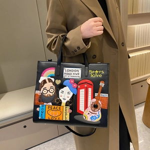 Retro black tote bag with London theme colorful patches and embroidery on model