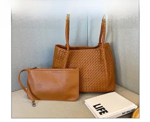 Close-up of brown woven leather tote bag set with matching inner zipper pouch detail