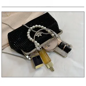 Vue intérieure montrant la grande capacité d'un sac de soirée en strass avec accessoires