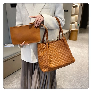 Detail of caramel woven tote and matching pouch set with thick leather texture