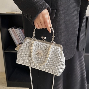Détail du sac de soirée en strass blancs avec anse en perles et fermoir flocon de neige