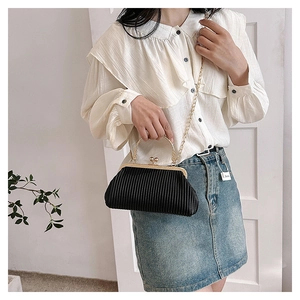 Elegant black pleated evening clutch with golden heart clasp and circular metal handle