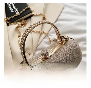 Detail of evening clutch handle with dual-row rhinestones and champagne gold ball clasp