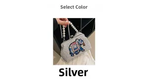 Close-up of silver elephant evening bag with shimmering rhinestones and pearl handle