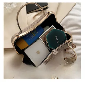 Macro view of champagne glitter evening bag interior with cosmetics and gold chain