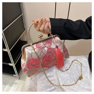 Close-up of elegant floral jacquard handbag with vintage rose embroidery and metal handle