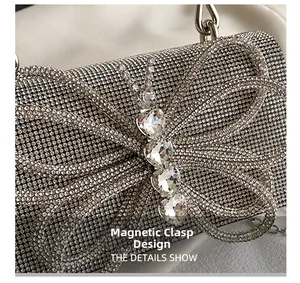 Detail of silver rhinestone evening bag featuring a crystal butterfly and magnetic closure
