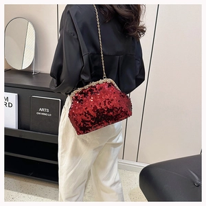 Detailed view of red sequin evening bag with crystal trim and gold metal chain strap