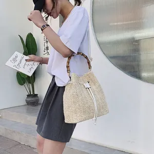 Retro cream woven straw bucket bag with bamboo handles and adjustable shoulder strap