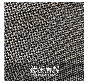 Macro detail of high-quality silver rhinestones densely arranged on a fashion handbag