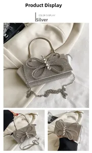 Detail of silver rhinestone evening bag with crystal bow and round metal handle