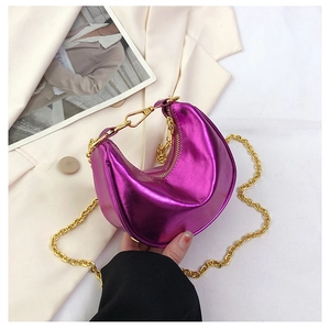 Close-up of metallic purple croissant bag with sleek golden chain strap and high-gloss finish