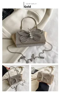 Close-up of gold sparkling rhinestone evening bag with elegant butterfly crystal decor