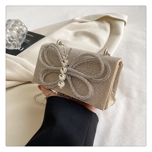 Close-up of sparkling heart diamonds and bow design on the rhinestone evening clutch