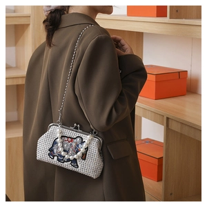 Detailed shot of ethnic elephant crossbody bag with rhinestones and pearl handle