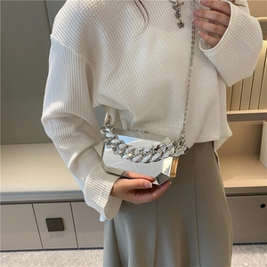 Futuristic silver metal box bag with thick chain strap and geometric faceted design