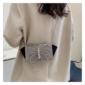 Detail of evening bag showing a large crystal butterfly and heart-shaped rhinestone