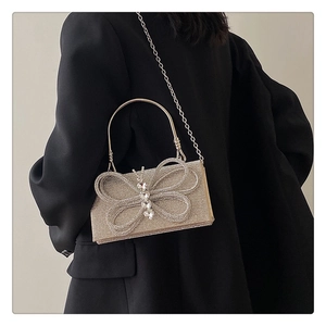 Detailed view of luxury rhinestone evening bag with elegant crystal butterfly knot accent