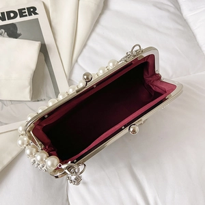 Ethnic elephant shoulder bag with pearl trim and red lining in elegant silver frame