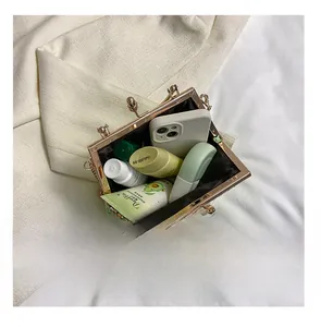Internal view of green quilted handbag showing capacity for phone, lipstick and cream