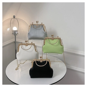 Detail of vintage pleated clutch bags with floral embossed gold frames and metal handles