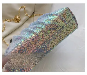 Detail shot of the flat bottom structure of a shimmering sequin evening clutch bag