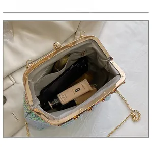 Internal view of blue sequined evening clutch bag showing storage capacity for essentials