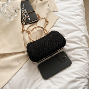 Sparkly black semi-circular evening clutch bag with gold handle and chain strap