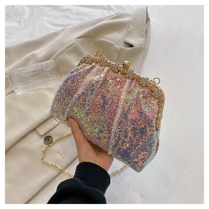 Detail of iridescent sequined evening bag with floral rhinestones and gold chain strap